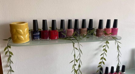 Nail polishes on a shelf at Gardenia Beauty Mobile Treatments in Blackpool, England, GB, highlighting vibrant colors.