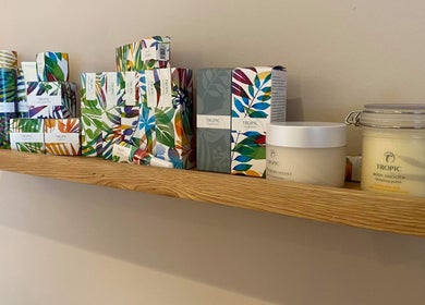 Gardenia Beauty Mobile Treatments in Blackpool, England offers vibrant Tropic products on wooden shelf.