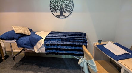 Cozy treatment room at Gardenia Beauty @Lakeside in Hambleton, England, GB with a plush bed and relaxing decor.