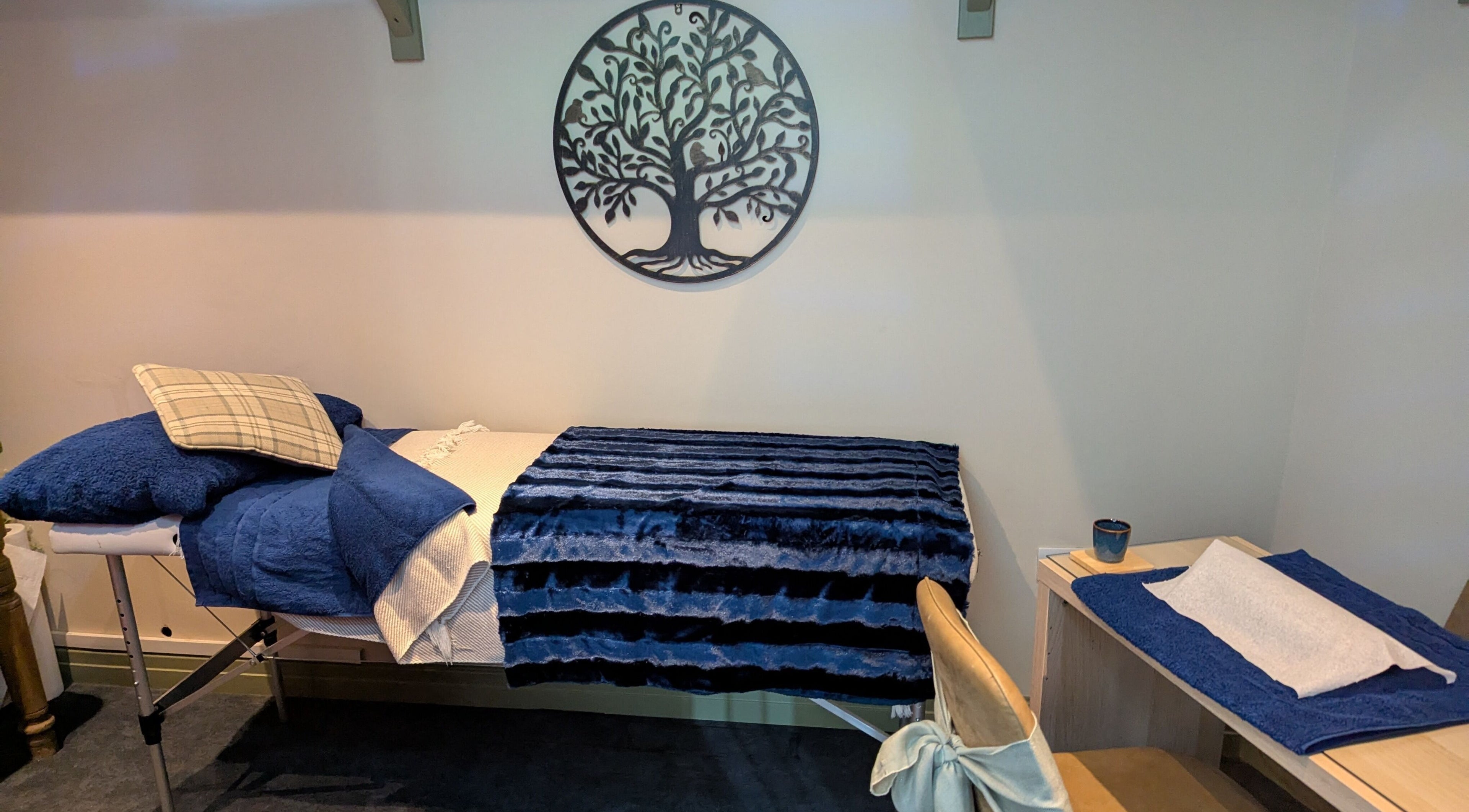 Relaxing treatment room at Gardenia Beauty at Lakeside, Hambleton, England, GB, with cozy blue decor.