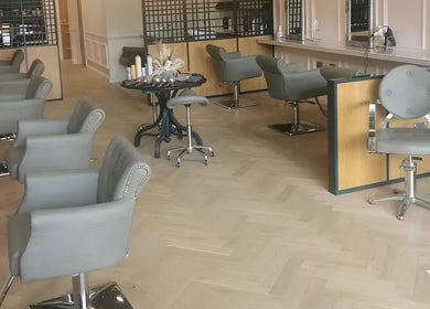 Chic salon interior at FAB Facial Aesthetics & Beauty in Dunstable, England, GB with stylish chairs and mirrors.