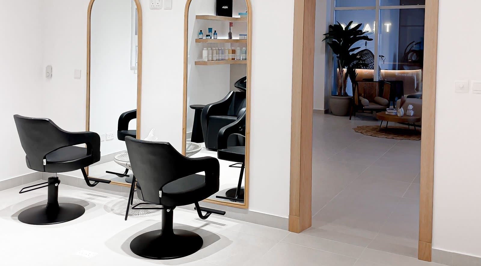 Elegant salon space at Tiara The Spa, الخبر, المنطقة الشرقية, SA, with black chairs and mirrors.