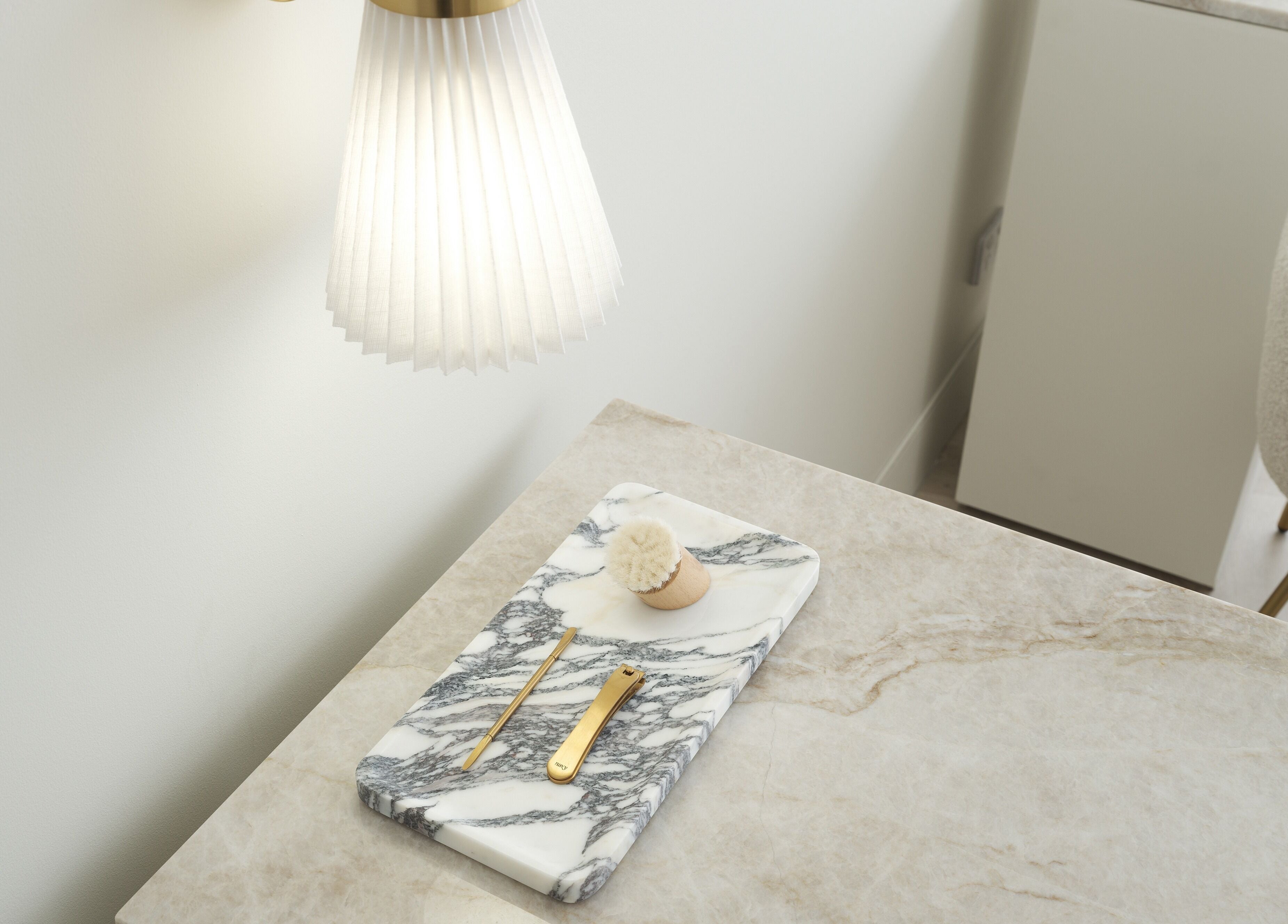Elegant desk at The Atelier Double Bay in Double Bay, New South Wales, AU with marble tray and gold accessories.
