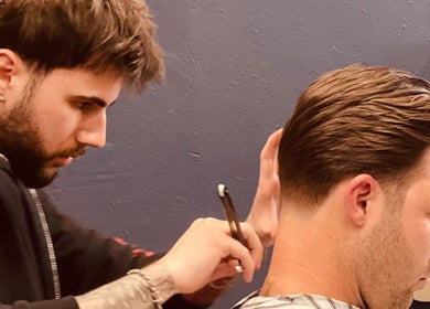 Professional barber cuts hair at Grand Royal Barbers - Darlinghurst, Sydney, New South Wales, AU.