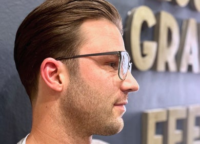 A stylish man with glasses at Grand Royal Barbers - Darlinghurst, Sydney, New South Wales, AU.