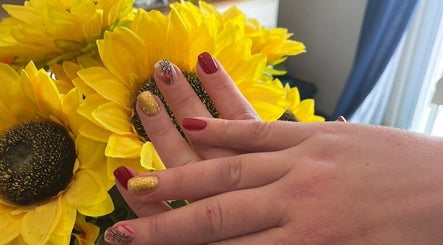 Stylish nail art at Star Glam Nails, Sandton, Gauteng, ZA, featuring sunflower-inspired designs and bright colors.