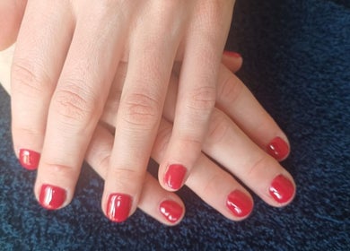 Red manicured nails showcase elegance at Star Glam Nails, Sandton, Gauteng, ZA.