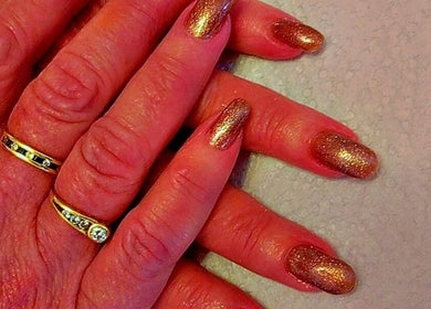 Close-up of sparkling golden nails at Star Glam Nails, Sandton, Gauteng, ZA showcasing elegant nail art.