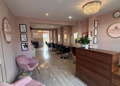 Interior of Trim N Tonic hair salon in Teignmouth, England, GB featuring chic decor and comfortable seating.