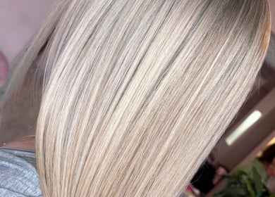 Sleek, straight blonde hair showcased at Trim N Tonic, Teignmouth, England, GB, highlighting expert styling.