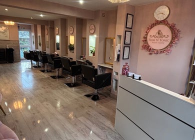 Interior of Trim N Tonic salon in Teignmouth, England, GB, showcasing modern decor and styling stations.