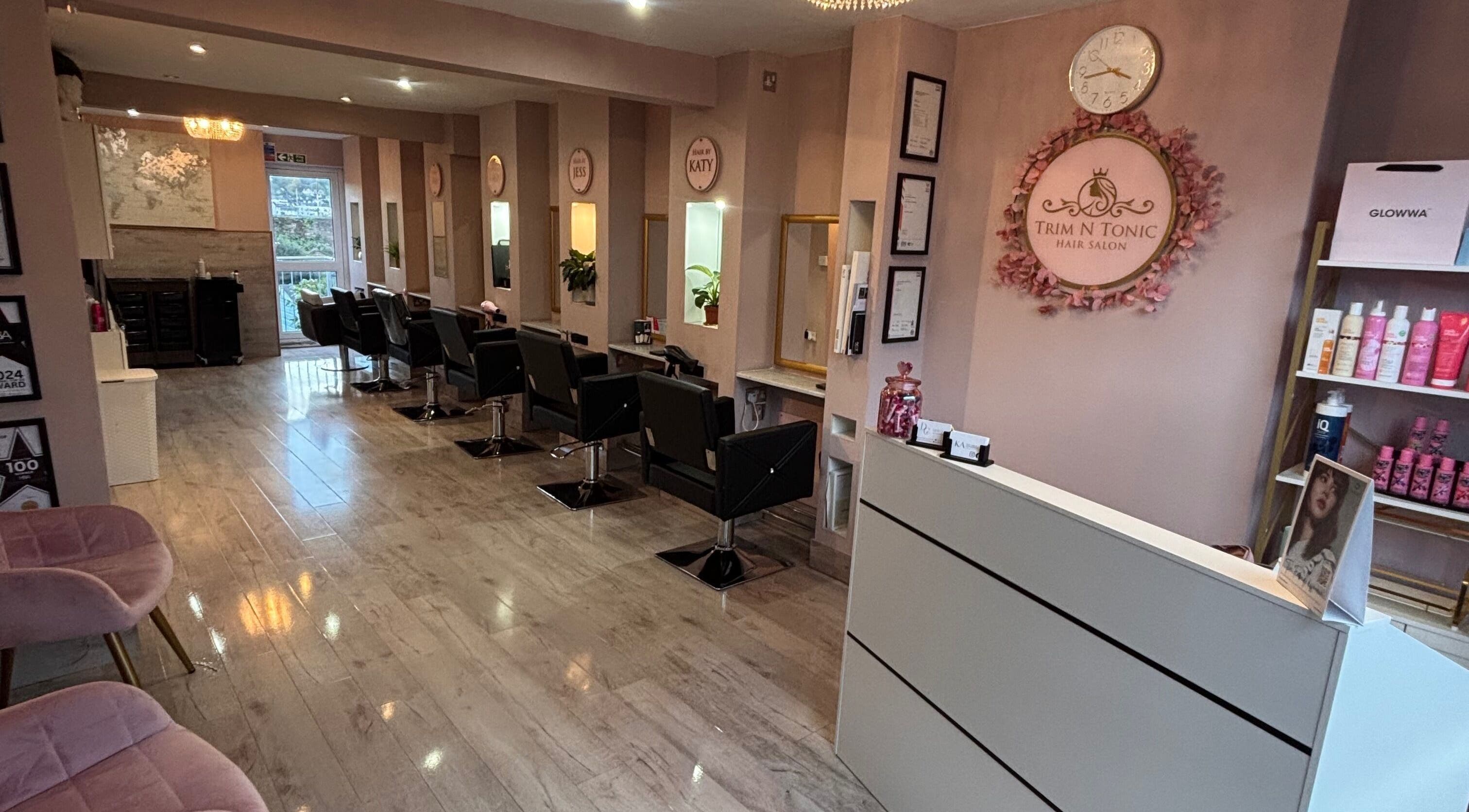 Interior of Trim N Tonic salon in Teignmouth, England, GB, showcasing modern decor and styling stations.