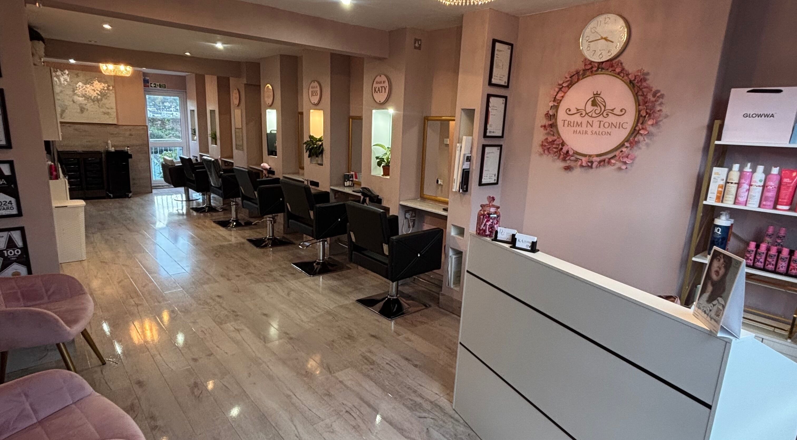 Interior of Trim N Tonic salon in Teignmouth, England, GB, showcasing modern decor and styling stations.