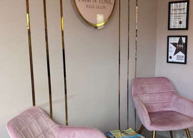 Elegant seating in Trim N Tonic salon, Teignmouth, England, GB, showcasing modern style and displayed awards.