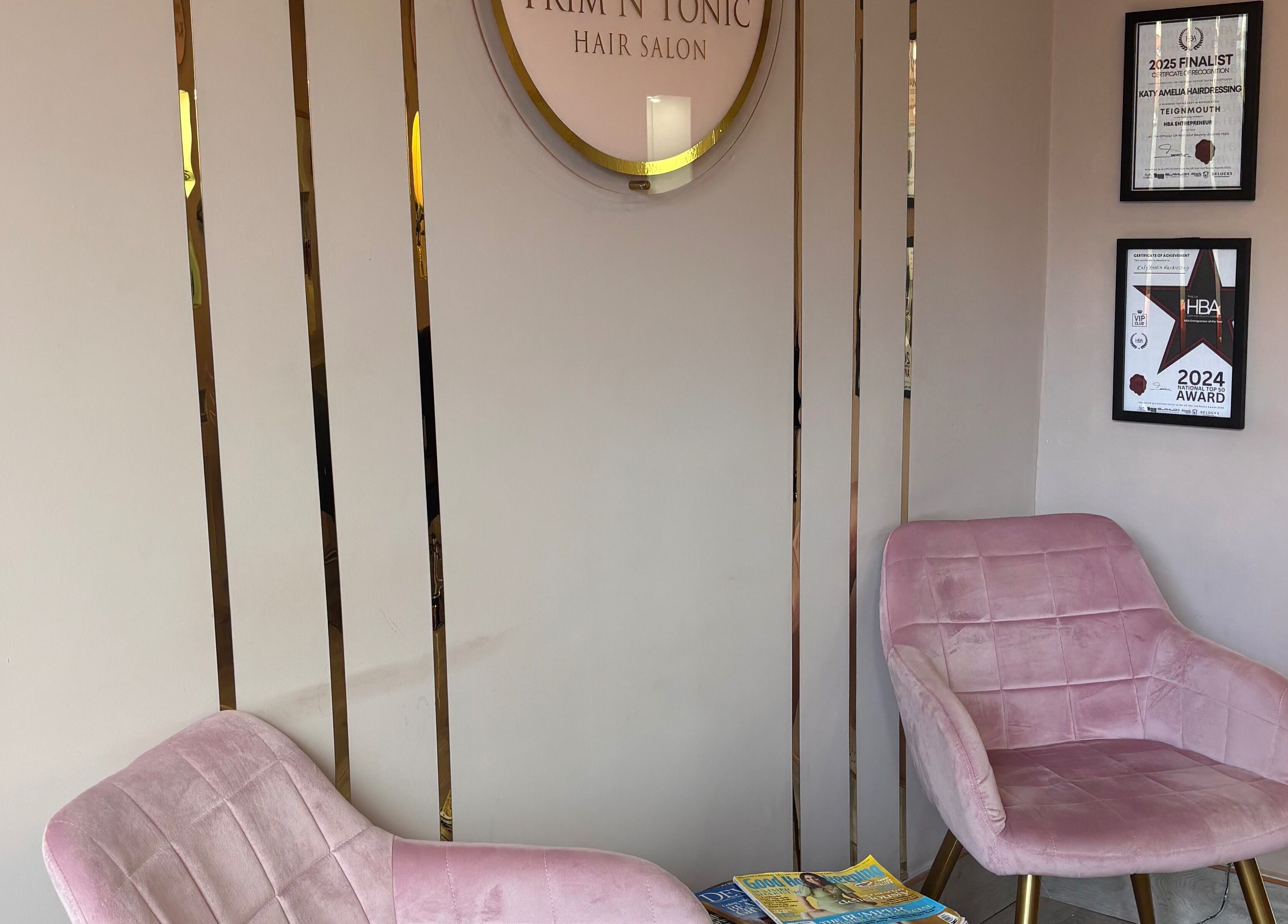 Elegant seating in Trim N Tonic salon, Teignmouth, England, GB, showcasing modern style and displayed awards.