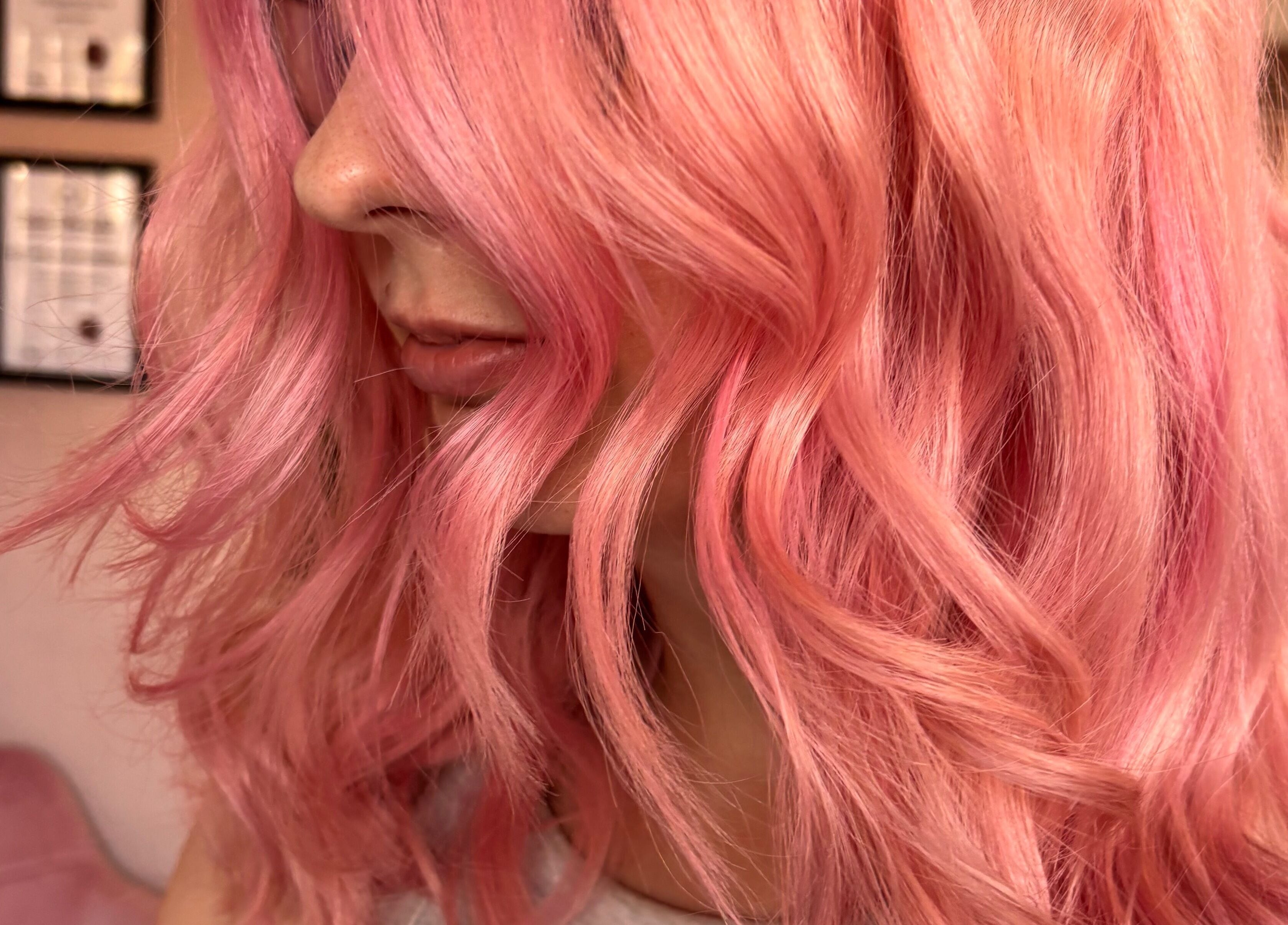 Close-up of pink wavy hair styled beautifully at Trim N Tonic, Teignmouth, England, GB.