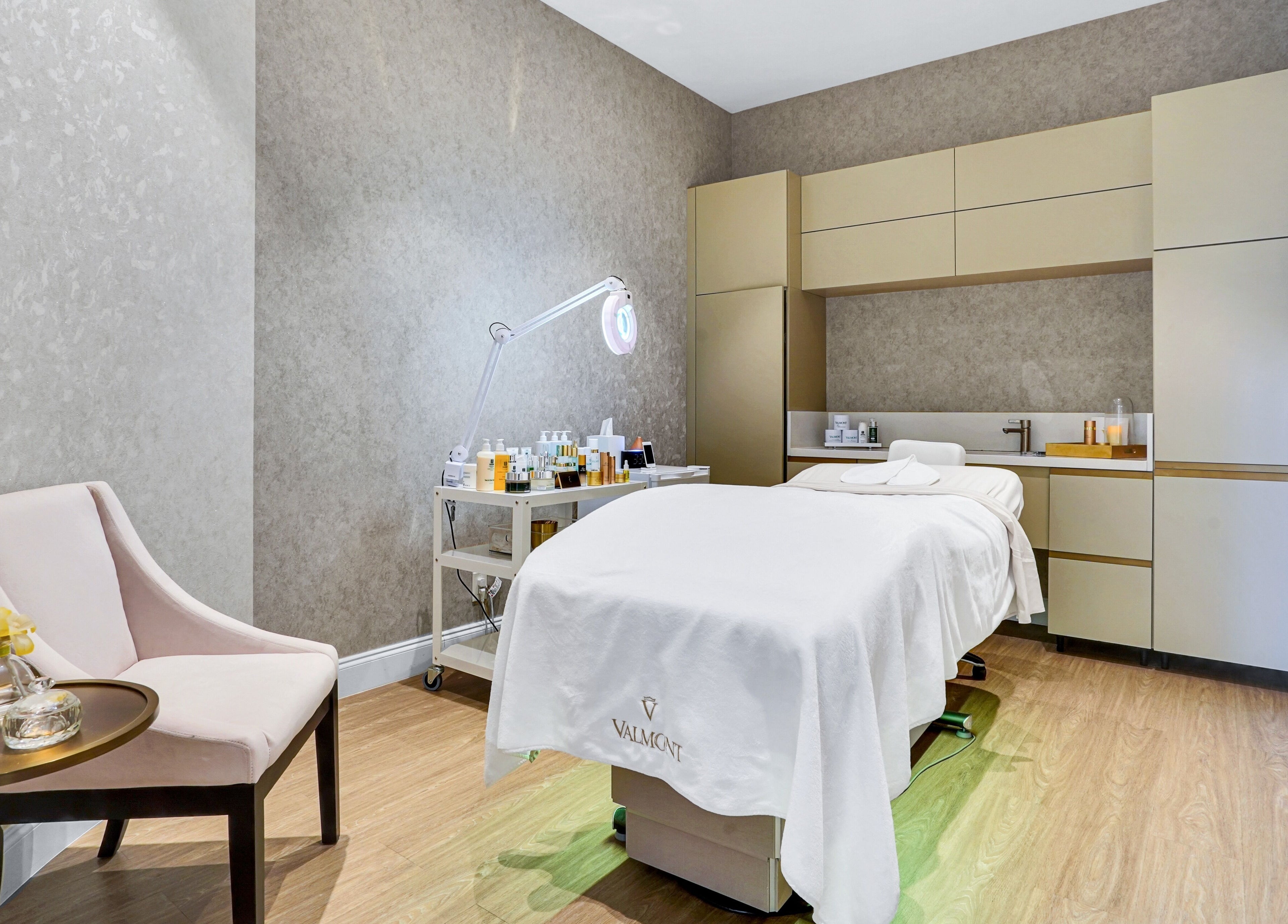 Tranquil spa room at Beauty Ambassade and Spa in West Palm Beach, Florida, US. Luxe treatment bed and soft lighting.