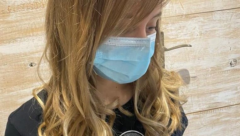 Customer with styled curls at Hair Logic in Alberton, Gauteng, ZA, showcasing salon quality.