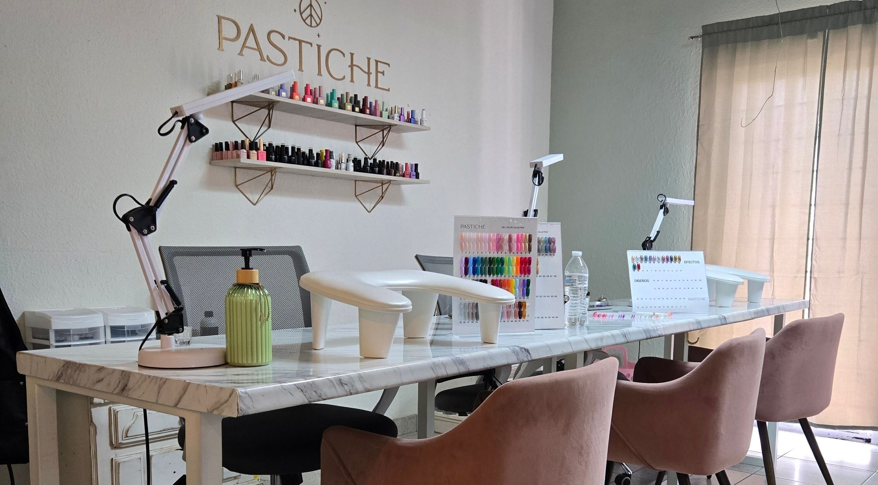Estación de manicura en Pastiche Studio, Chihuahua, Chihuahua, MX con sillas de terciopelo y esmaltes de uñas.