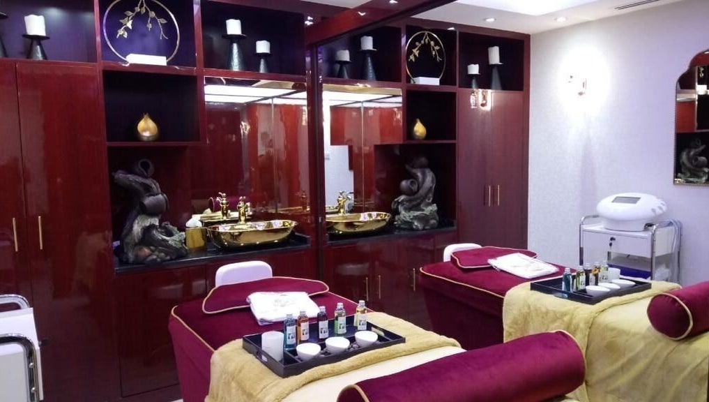 Elegant treatment room at The One and Only Madhu Beauty Lounge in Ajman, Ajman, AE with plush beds and gold accents.