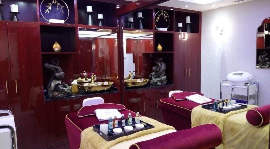 Elegant treatment room at The One and Only Madhu Beauty Lounge in Ajman, Ajman, AE with plush beds and gold accents.
