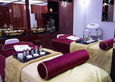 Elegant spa room at The One and Only Madhu Beauty Lounge, Ajman, AE, featuring plush treatment beds.