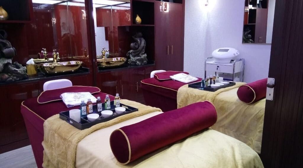Elegant spa room at The One and Only Madhu Beauty Lounge, Ajman, AE, featuring plush treatment beds.