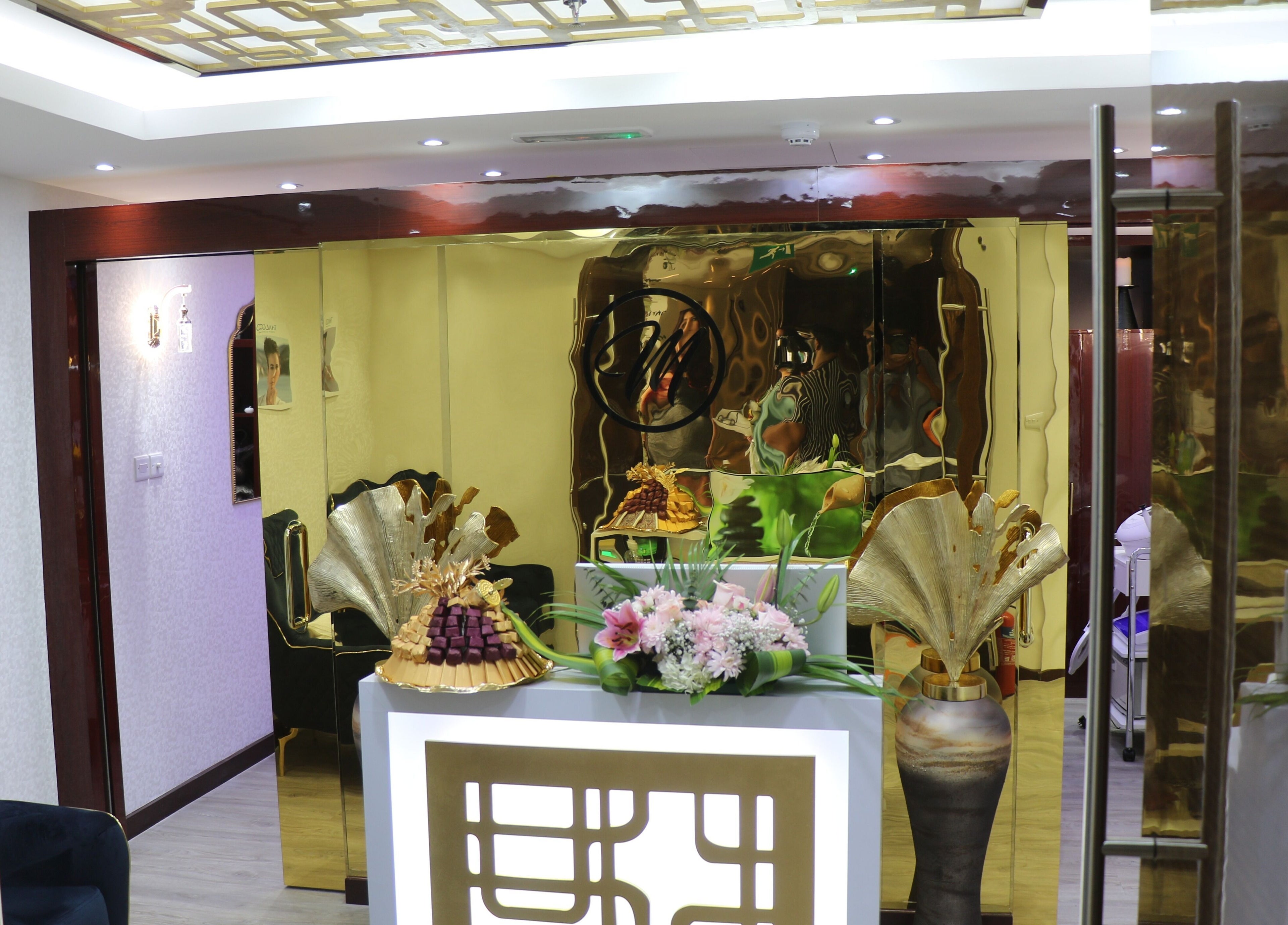 Elegant interior of The One and Only Madhu Beauty Lounge in Ajman, Ajman, AE featuring gold accents and decor.