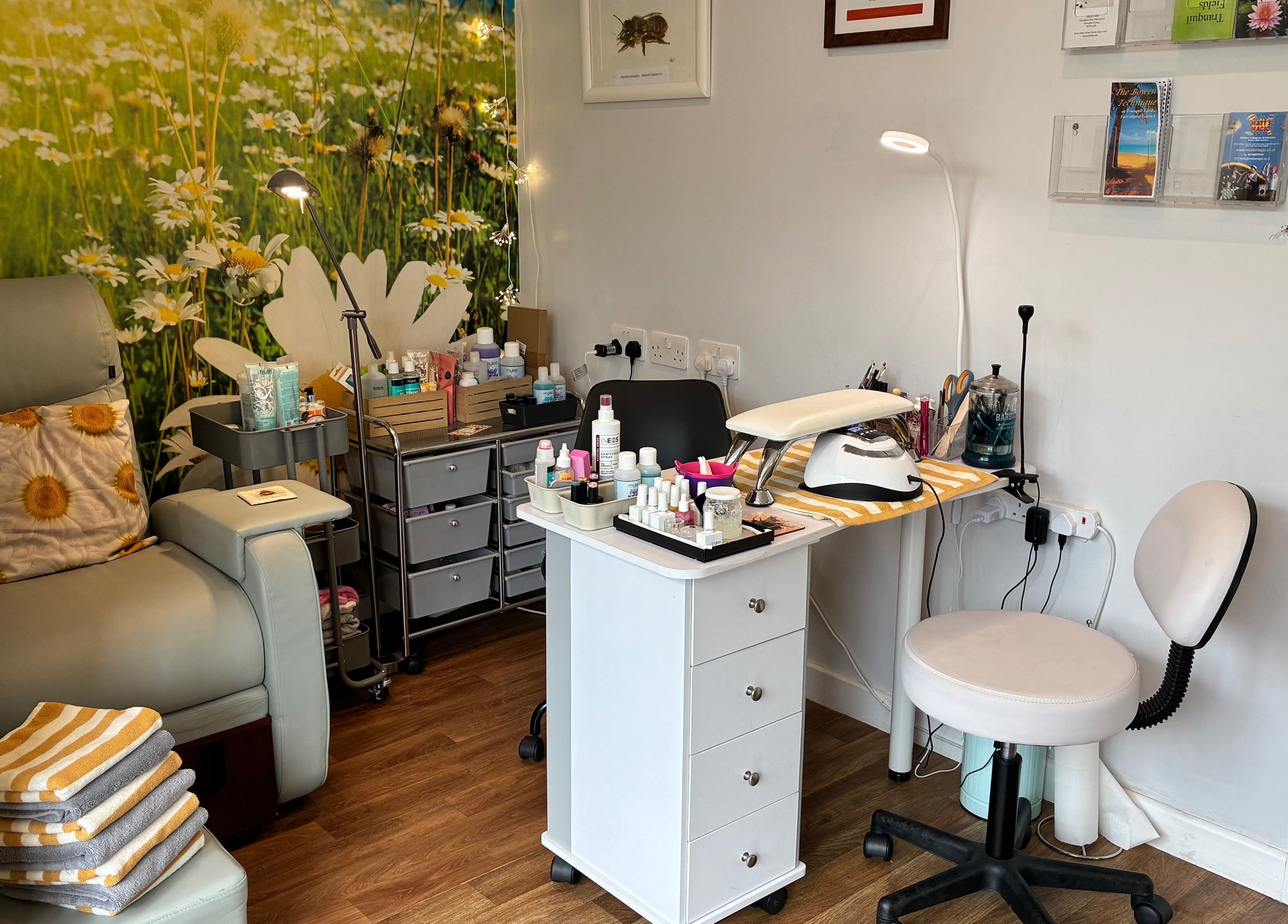 Relaxing beauty treatment area at Tranquil Fields, Farrington Gurney, England, GB with cozy seating and floral decor.