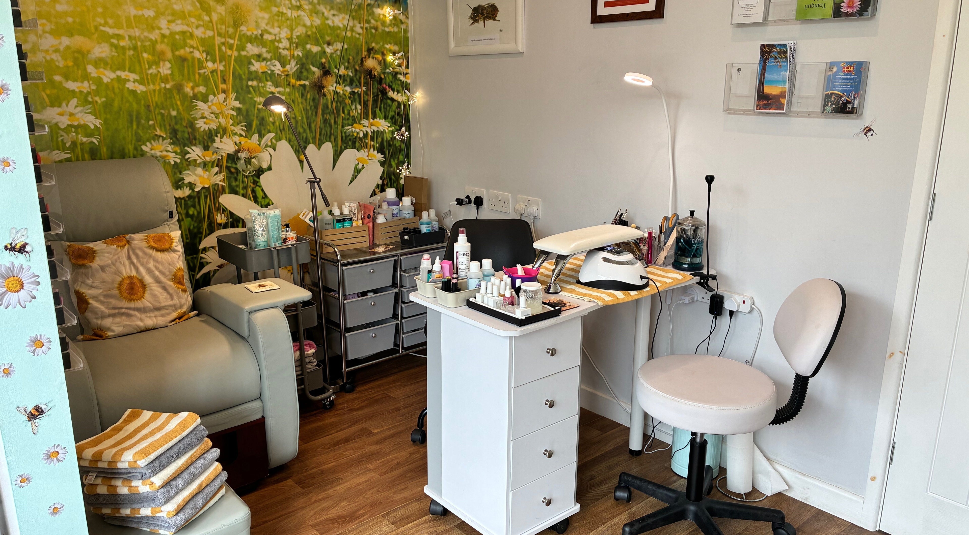 Relaxing beauty treatment area at Tranquil Fields, Farrington Gurney, England, GB with cozy seating and floral decor.