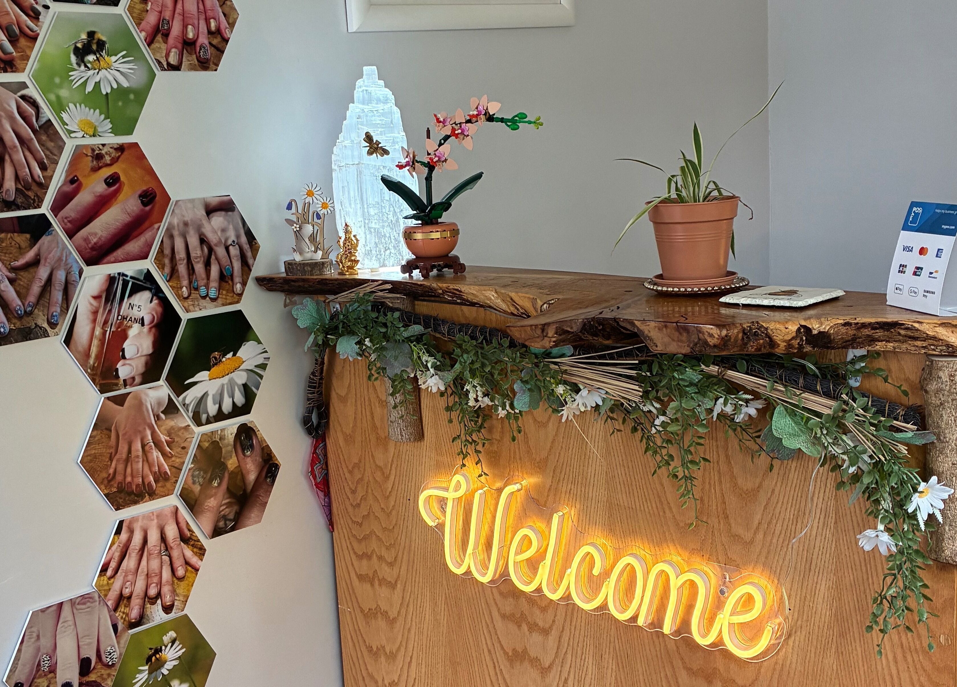 Reception at Tranquil Fields in Farrington Gurney, England features a wooden welcome sign with floral decor.