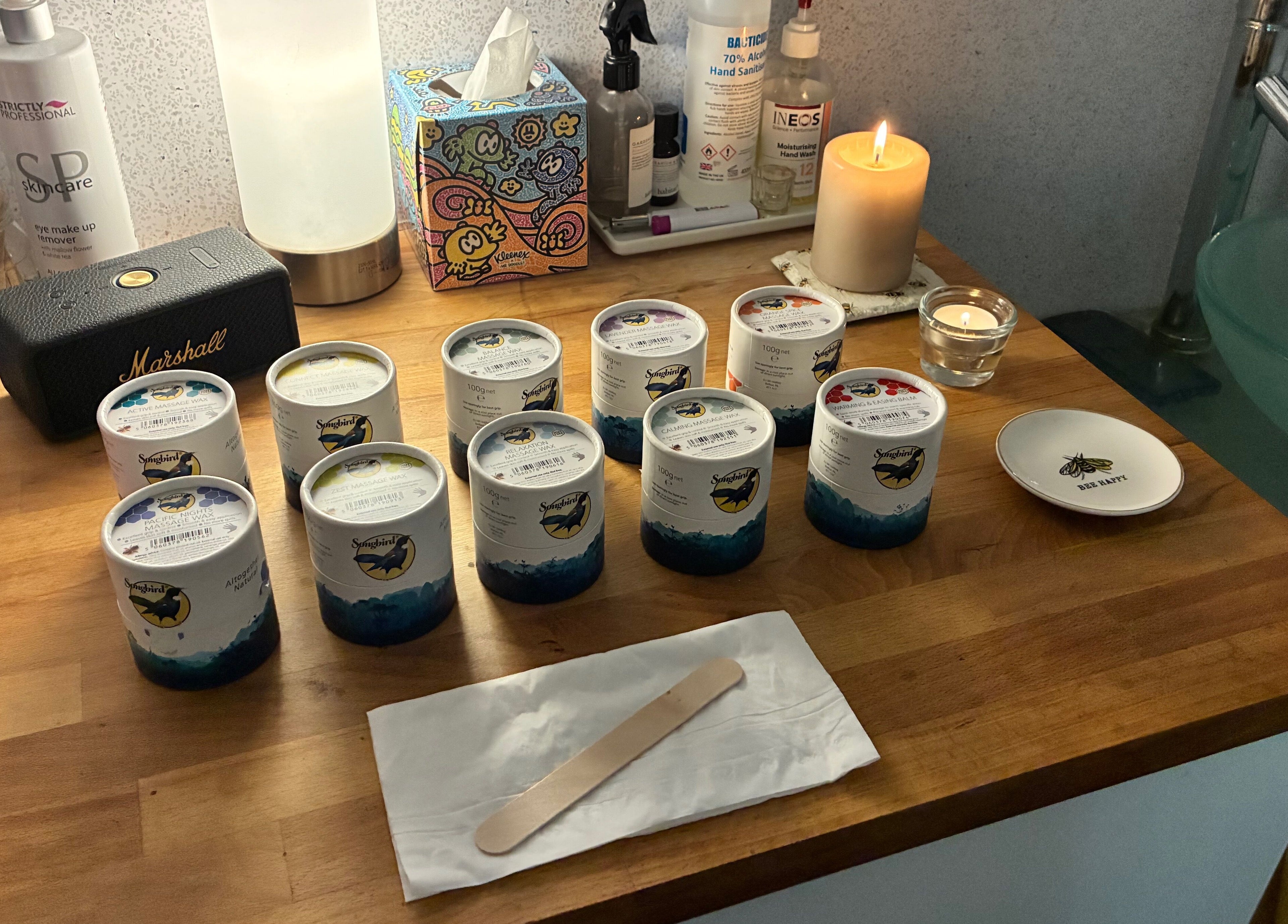 A tranquil spa countertop at Tranquil Fields in Farrington Gurney, England, GB with candles and skincare.