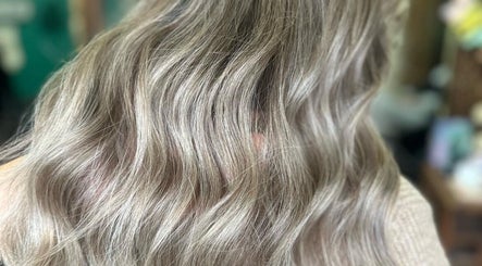 Elegant wavy hairstyle at JADE Hair, Congleton, England, GB showcasing glossy, light brown hair.