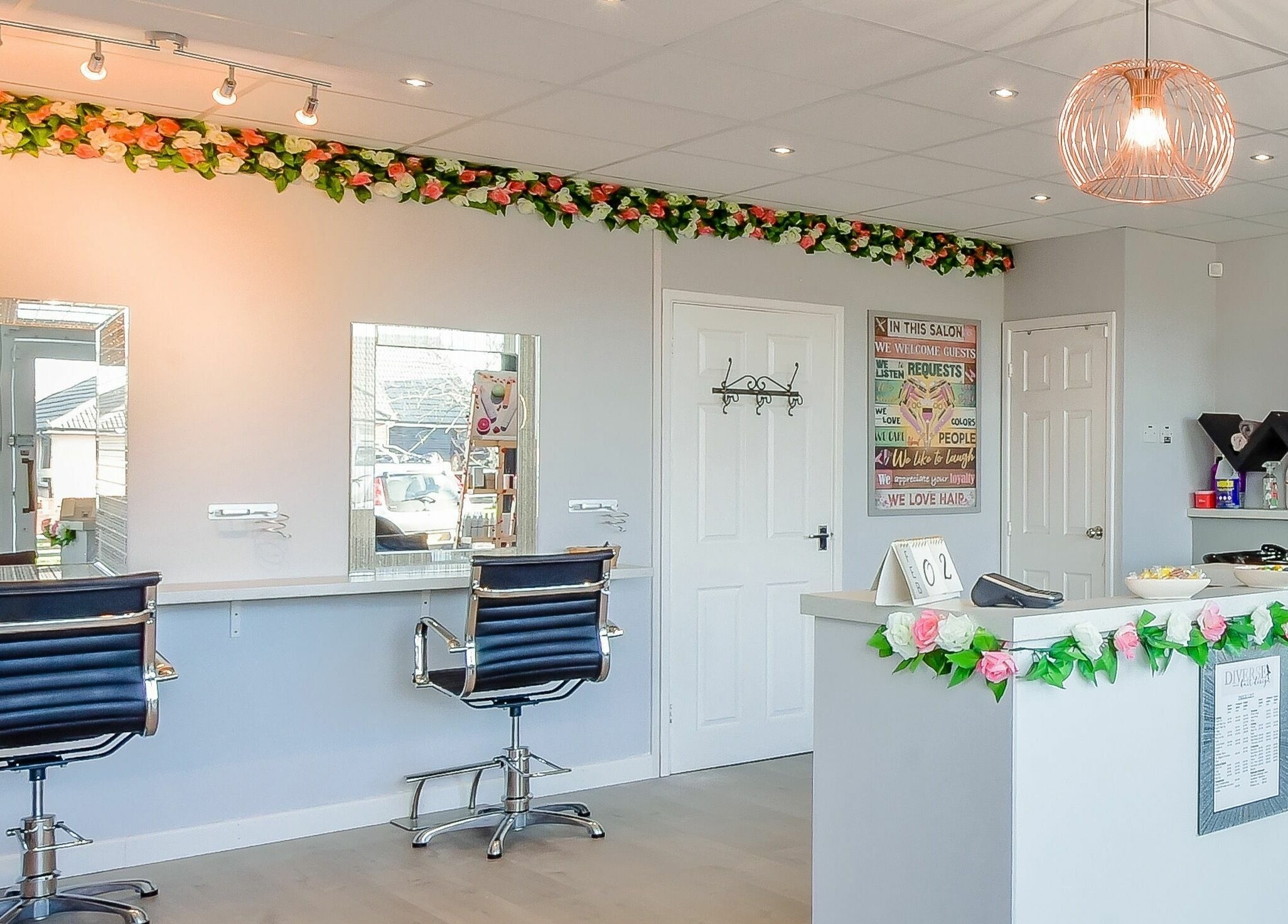Stylish interior of Diverse Hair Design in Waterlooville, England, GB, featuring elegant salon styling stations.