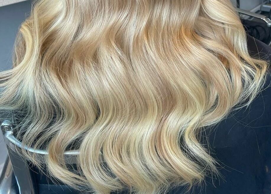 Elegant blonde waves styled at Diverse Hair Design in Waterlooville, England, GB salon.