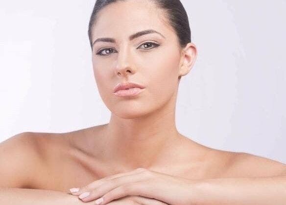 A woman with glowing skin at D Beauty Bar, Naxxar, MT, showcasing natural beauty and wellness services.