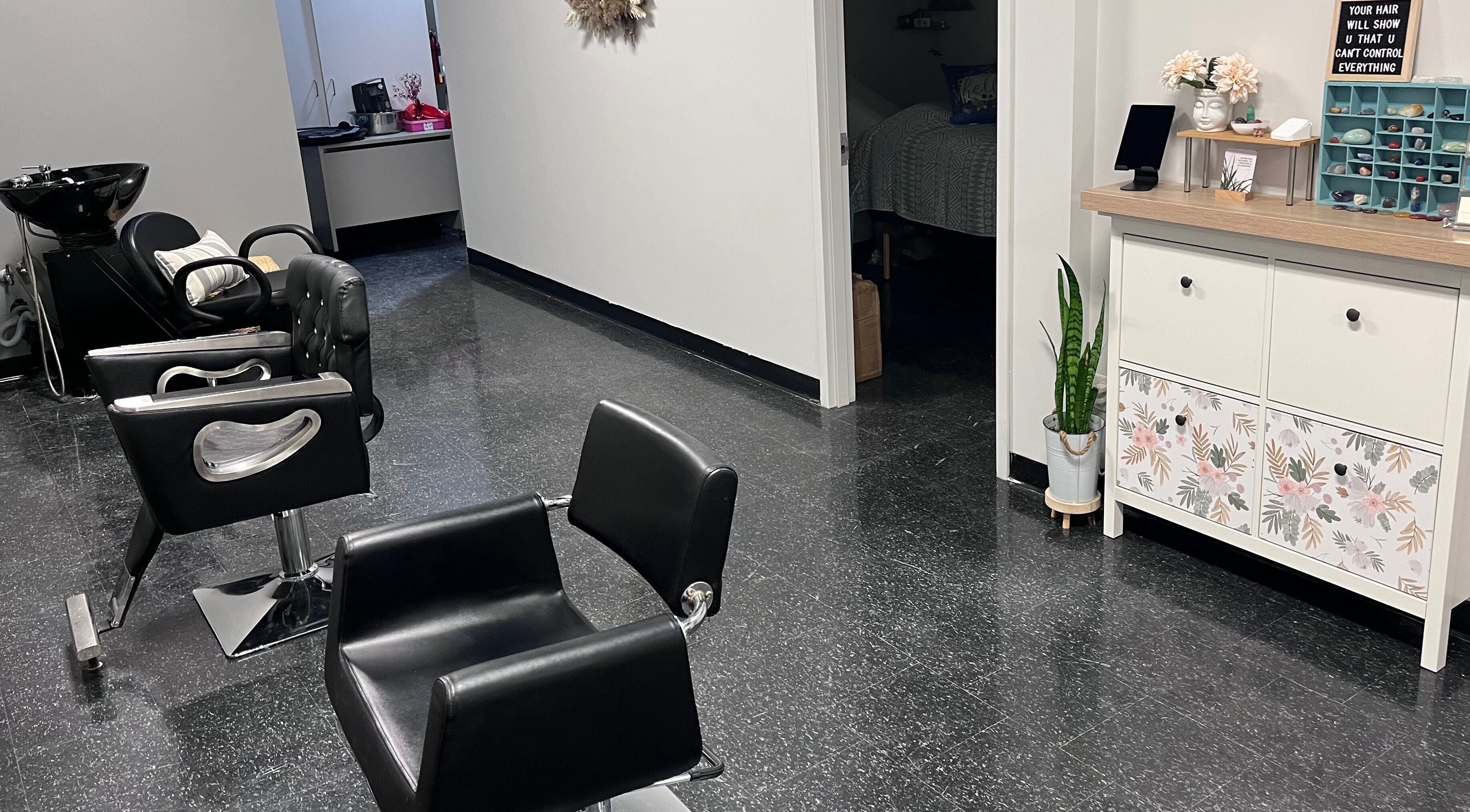 Stylish interior of Heal Hair Studio in Orangeville, Ontario, CA featuring modern salon chairs and decor.