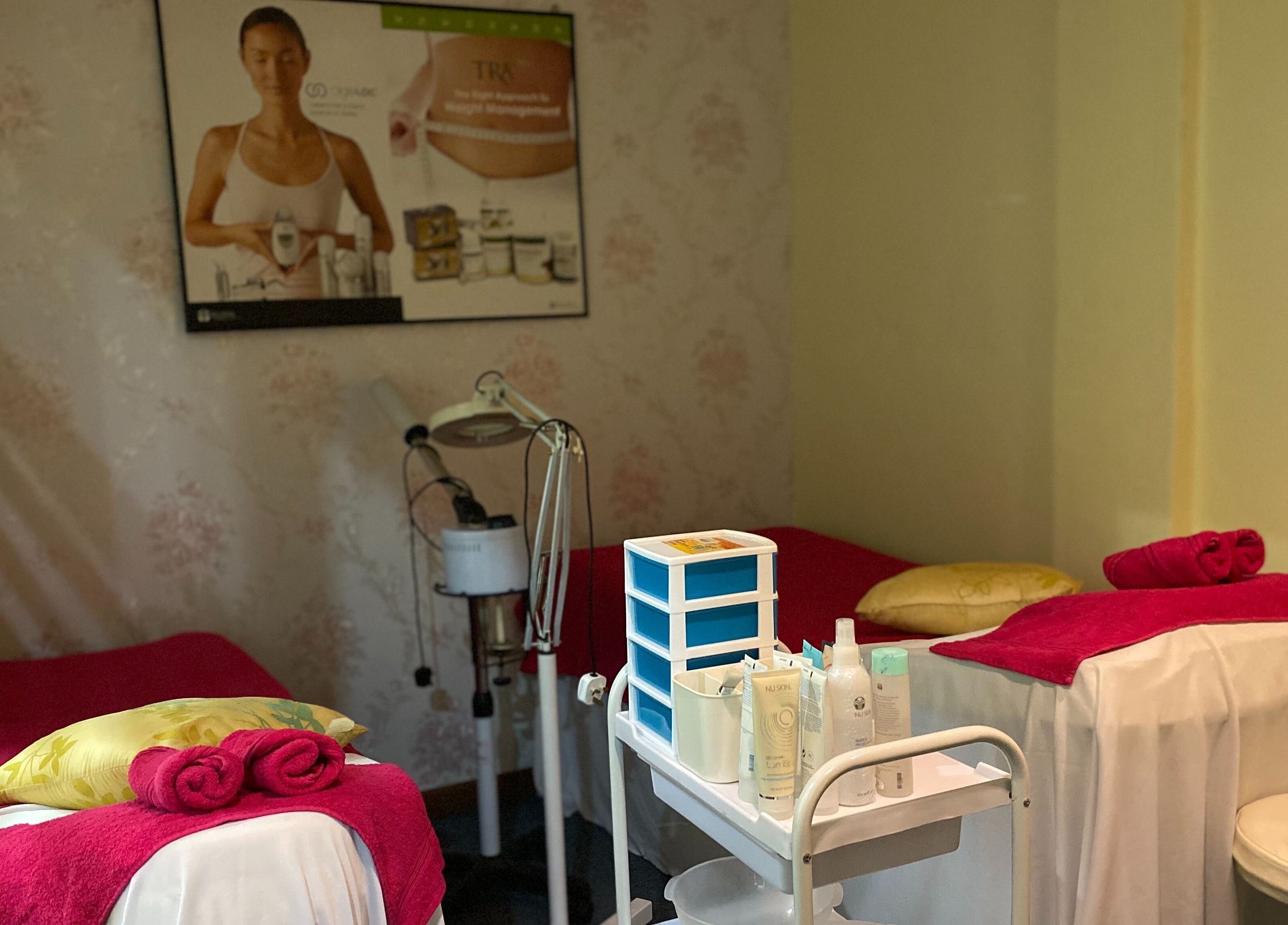 Cozy treatment room at Libo Spa in Alor Setar, Kedah, MY with vibrant towels and beauty products.