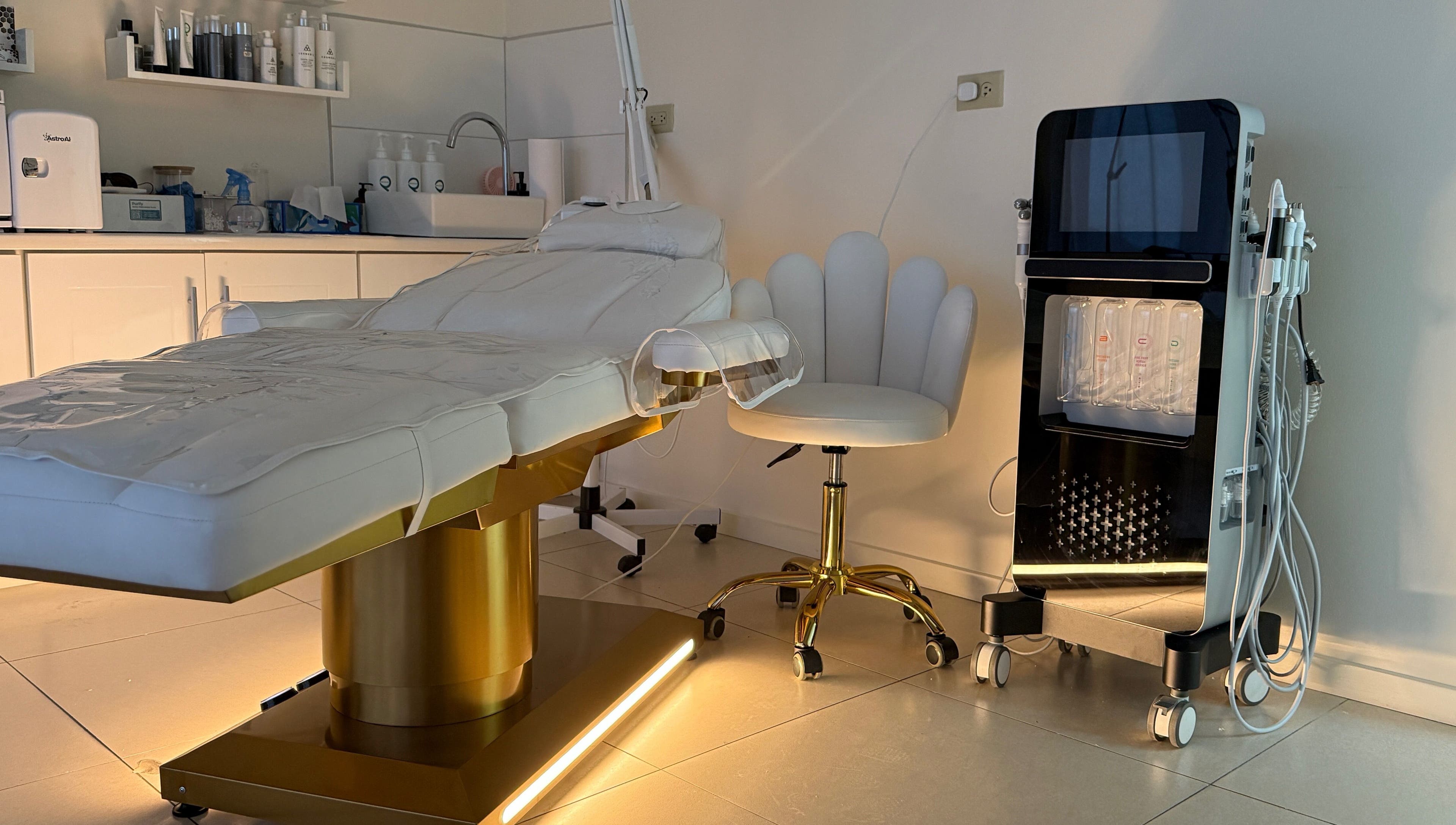 Luxurious therapy room at Enhance Aesthetics in Canaan, Tobago, TT featuring a modern treatment table and equipment.