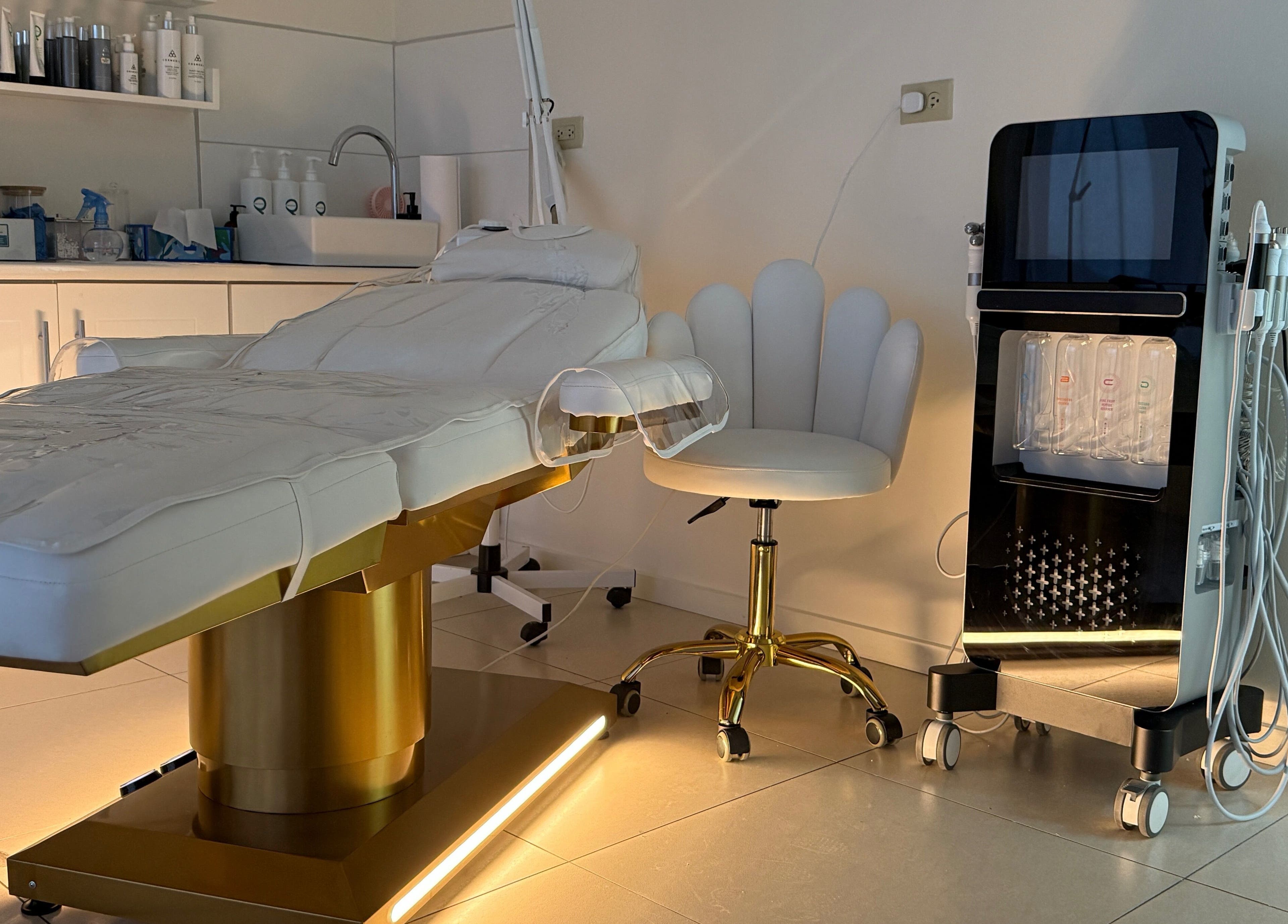 Luxurious therapy room at Enhance Aesthetics in Canaan, Tobago, TT featuring a modern treatment table and equipment.