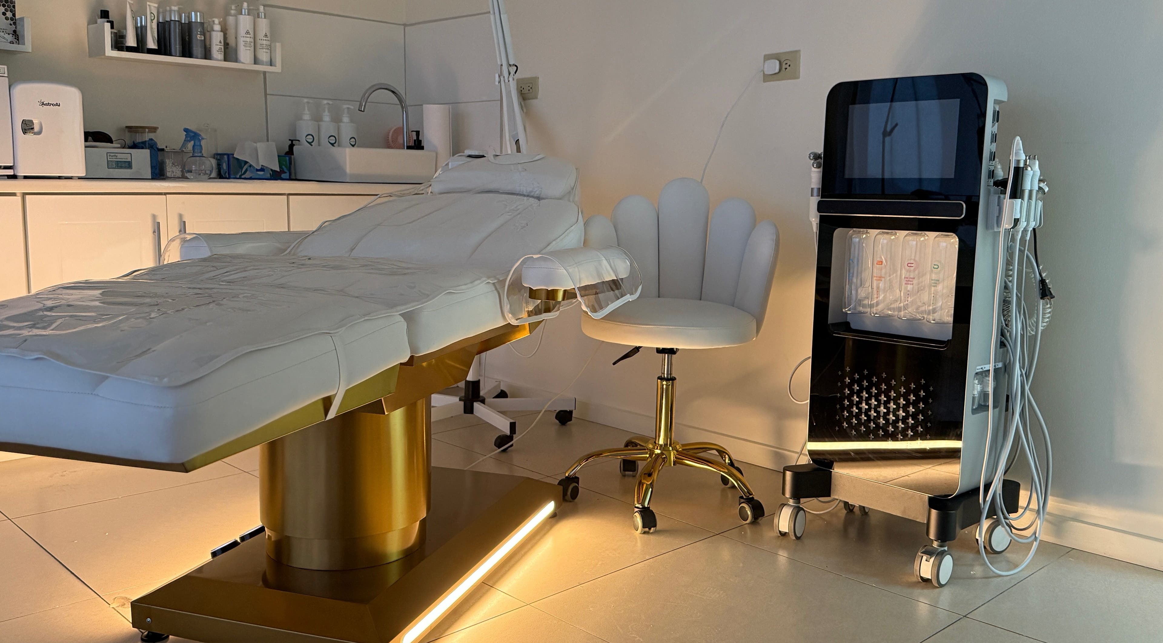 Luxurious therapy room at Enhance Aesthetics in Canaan, Tobago, TT featuring a modern treatment table and equipment.