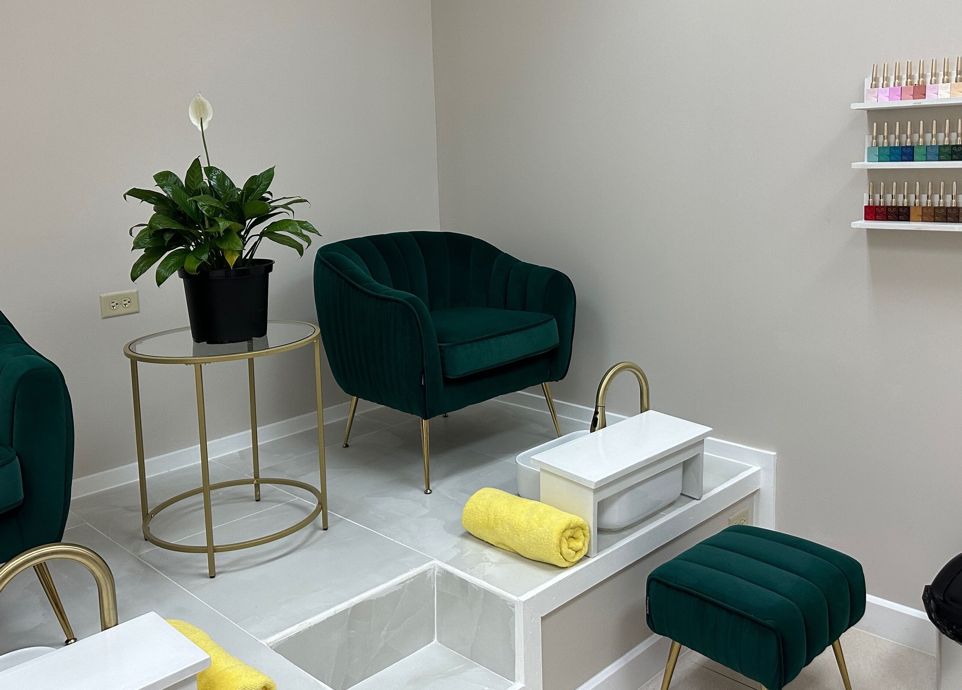 Luxurious pedicure area at Enhance Aesthetics, Canaan, Tobago, TT with plush chairs and nail polish display.