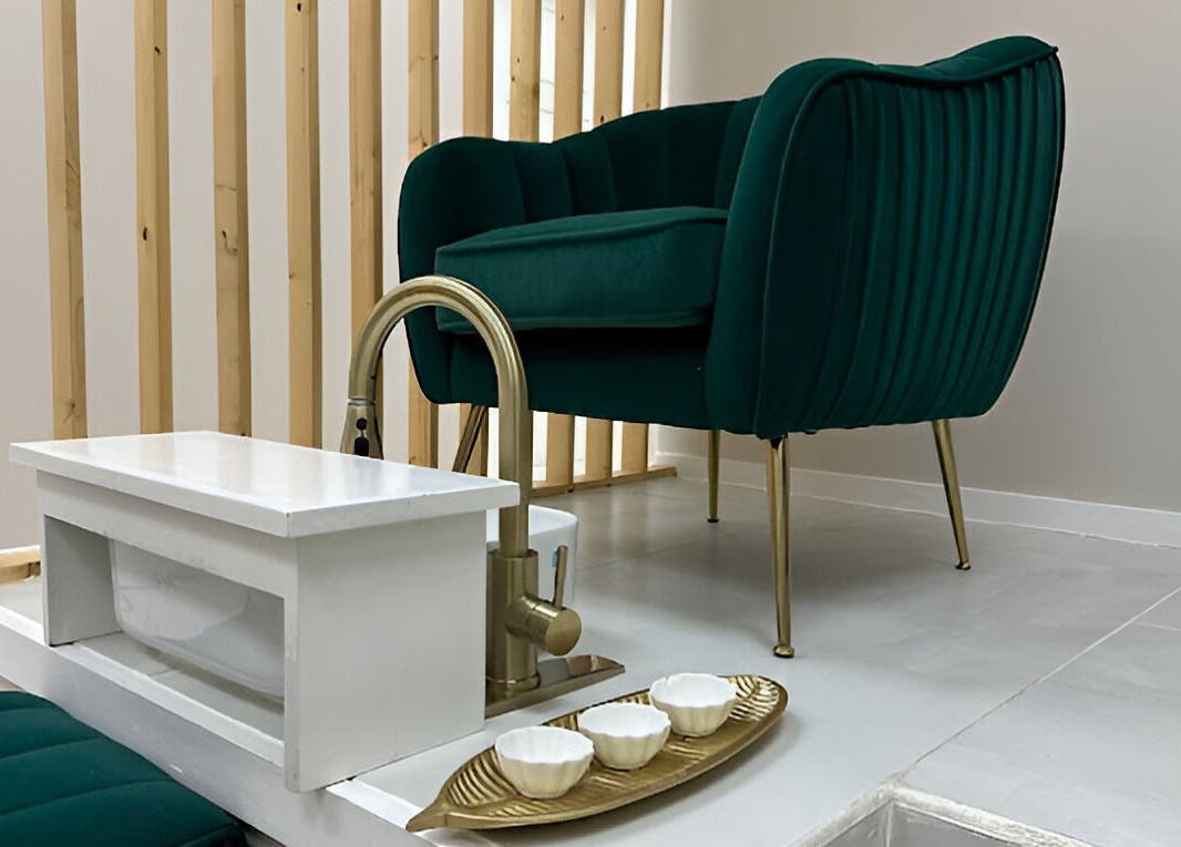 Modern pedicure station at Enhance Aesthetics in Canaan, Tobago, TT, featuring a plush green chair.