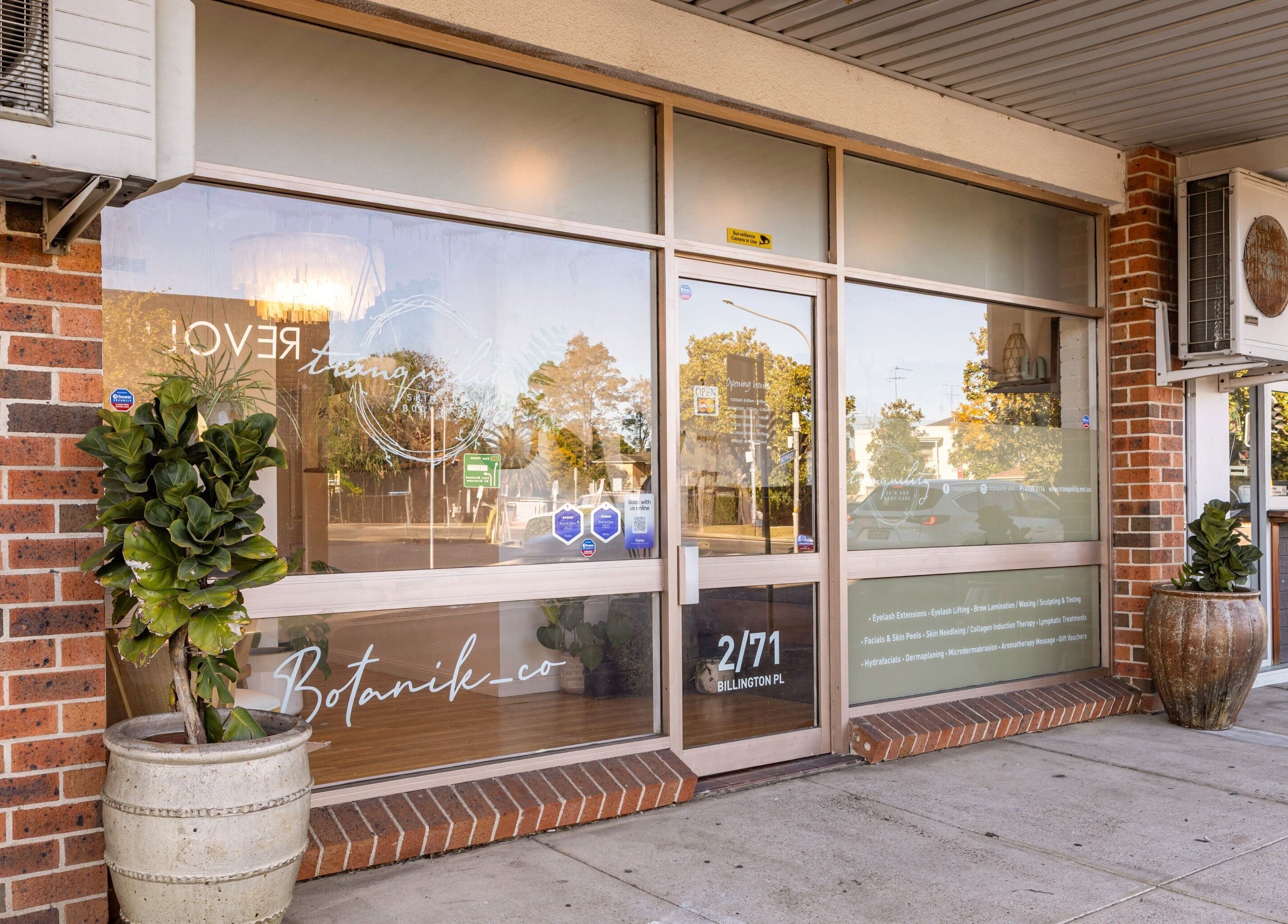 Front entrance of Tranquility Skin & Body Spa in Emu Plains, New South Wales, AU with glass doors and potted plants.