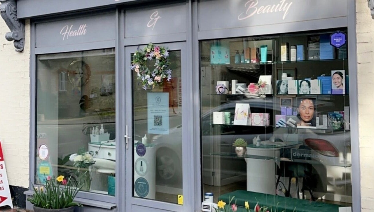 Charming storefront of Blossom Health and Beauty in Great Shelford, England, GB with vibrant decor.