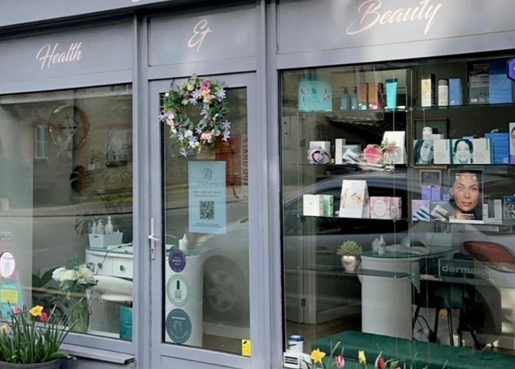 Charming storefront of Blossom Health and Beauty in Great Shelford, England, GB with vibrant decor.