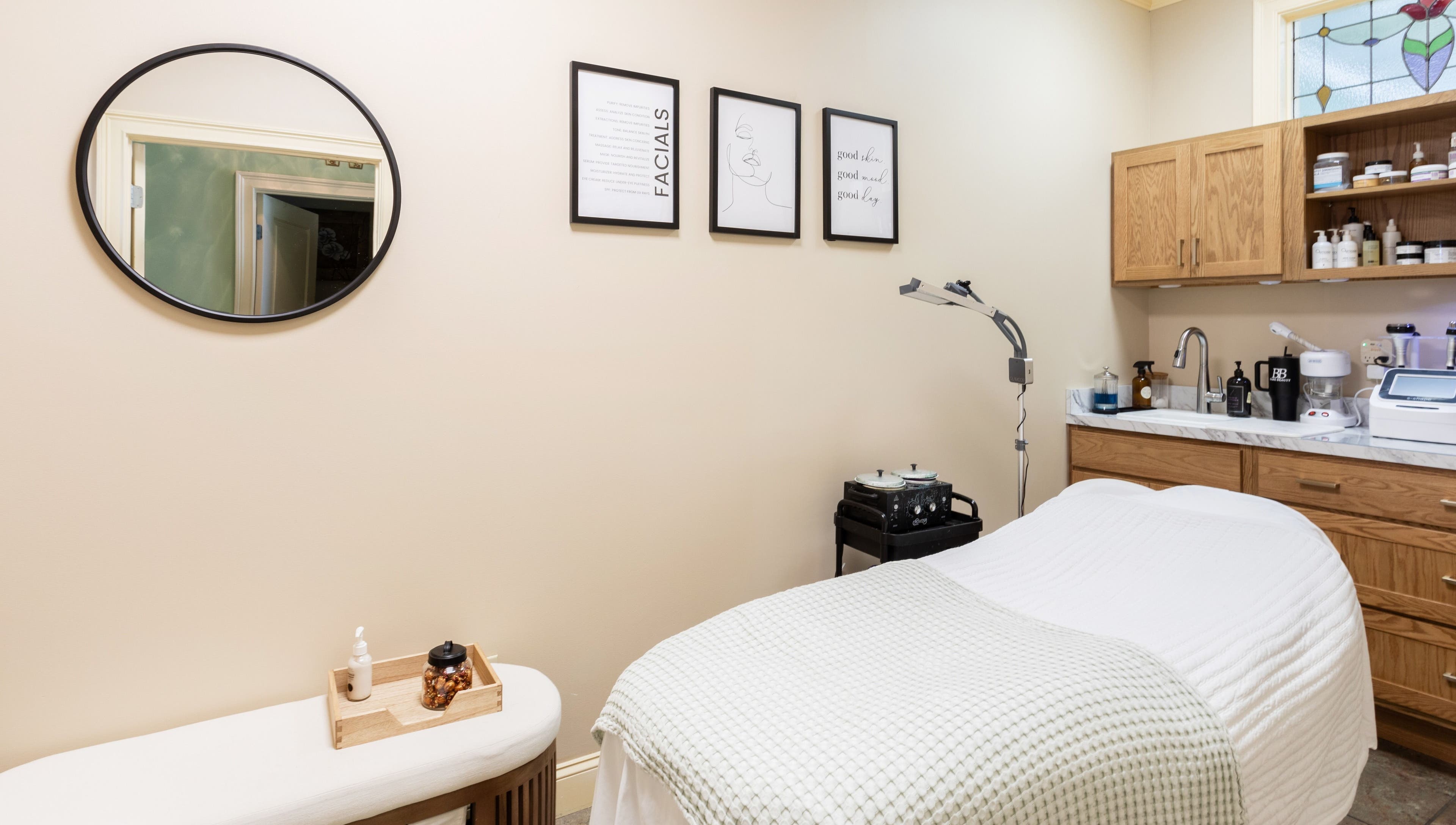 Cozy treatment room at Bare Beauty Aesthetics, Ludlow, Massachusetts, US, featuring a massage bed and warm decor.
