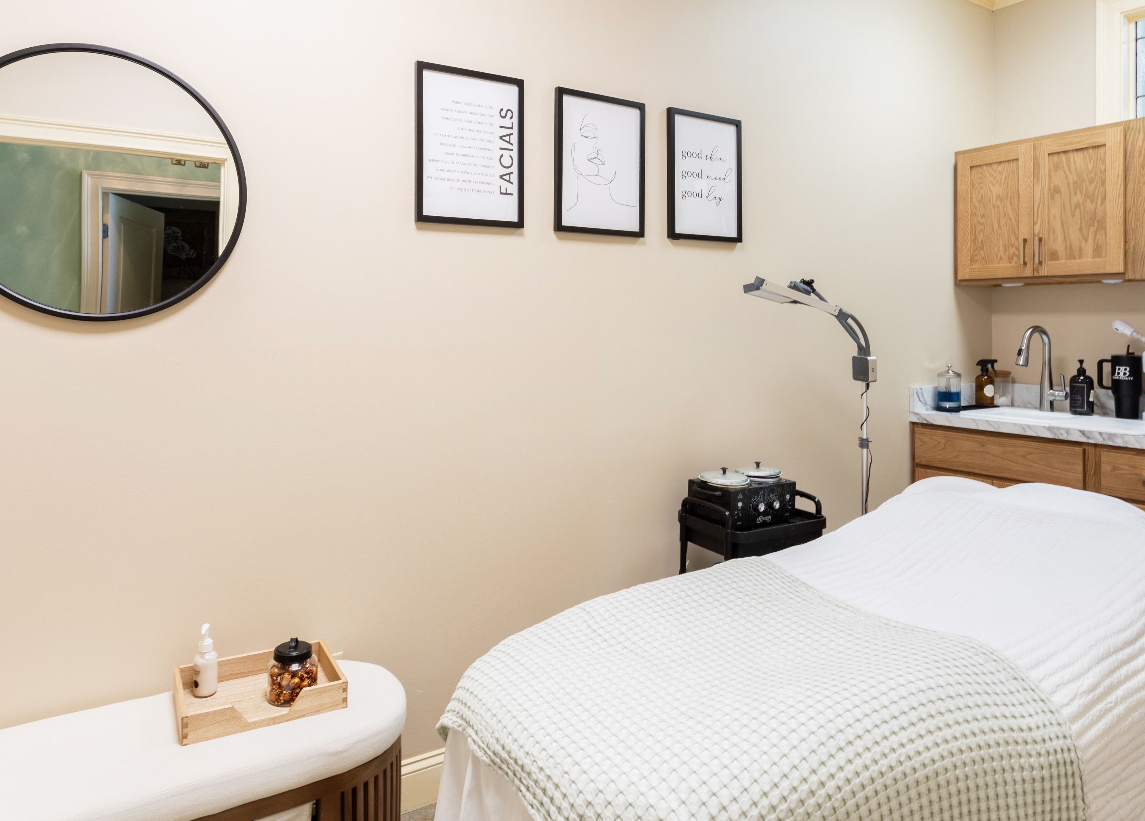 Cozy treatment room at Bare Beauty Aesthetics, Ludlow, Massachusetts, US, featuring a massage bed and warm decor.