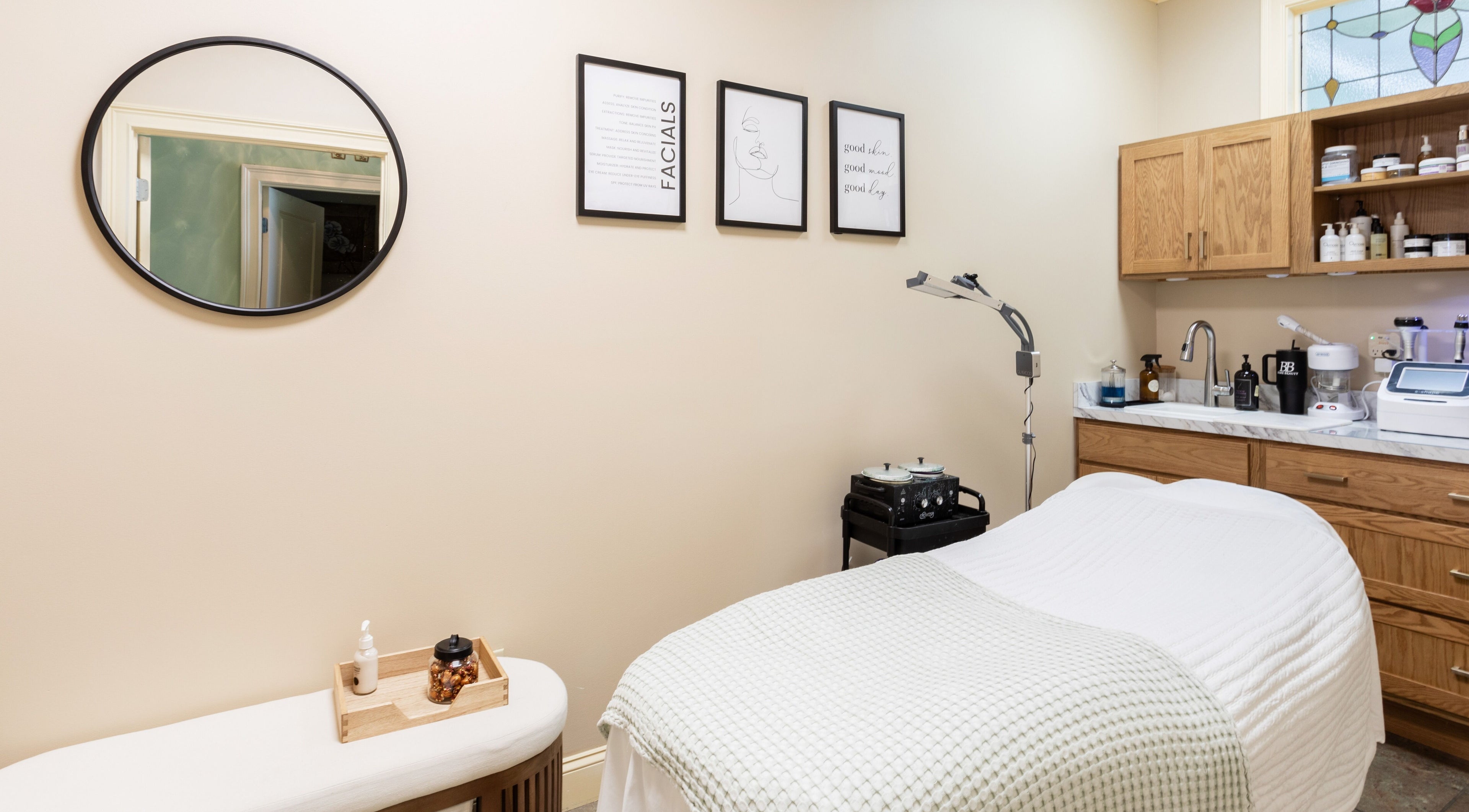 Cozy treatment room at Bare Beauty Aesthetics, Ludlow, Massachusetts, US, featuring a massage bed and warm decor.