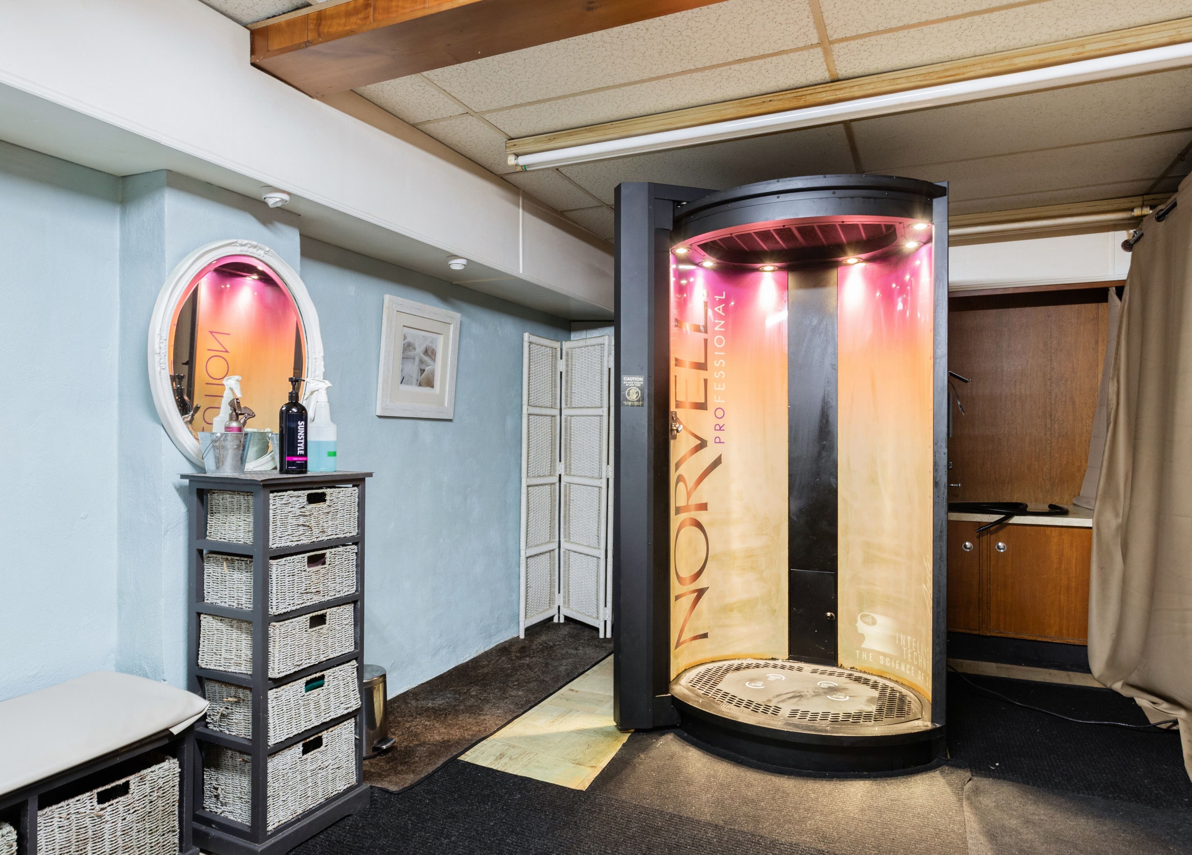 Tanning booth at Bare Beauty Aesthetics, Ludlow, Massachusetts, US, showcasing modern and inviting aesthetics.